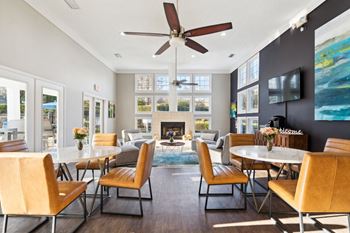 A living room with tables and chairs and a fireplace